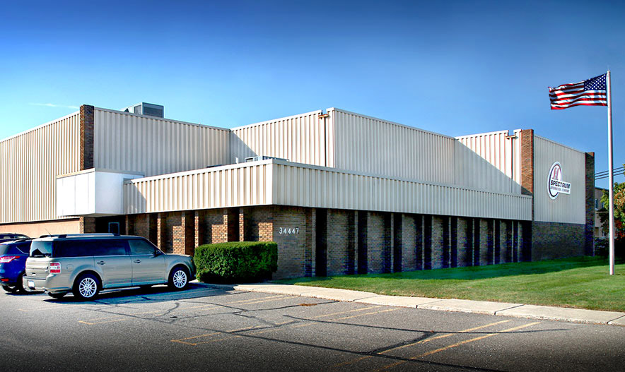 Image of a Factory with a parking lot in front