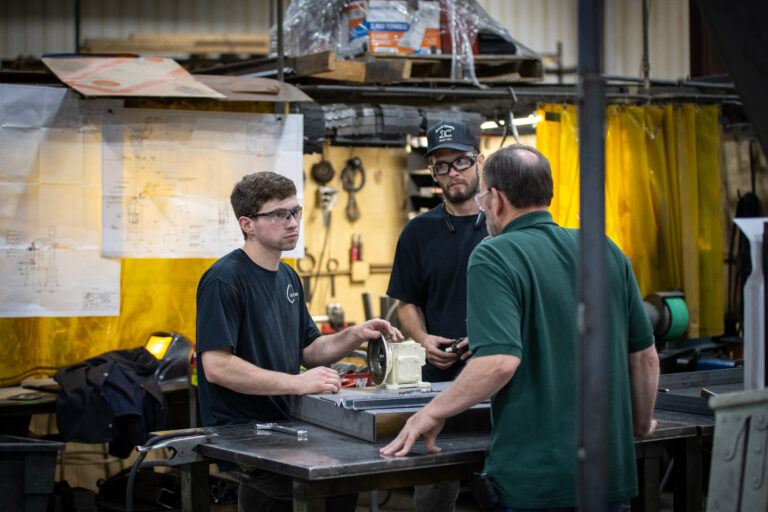 Man and others talking around a table